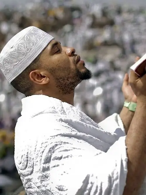 Pilgrim in white ihram making dua